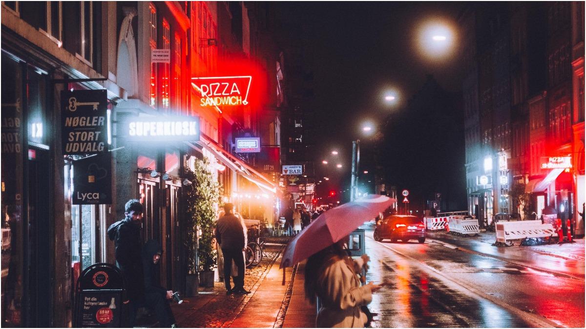 Neon-lit Copenhagen street at night in the rain